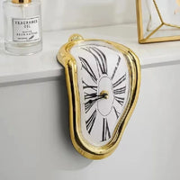 Horloge fondante inspiration Dali doré
